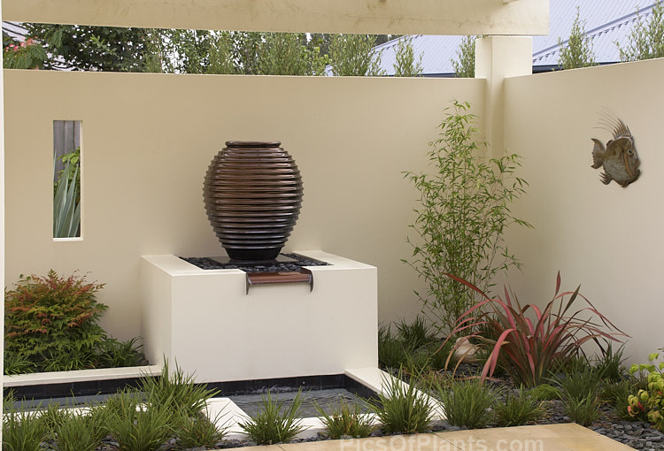 A bronze-coloured, urn-like water feature.