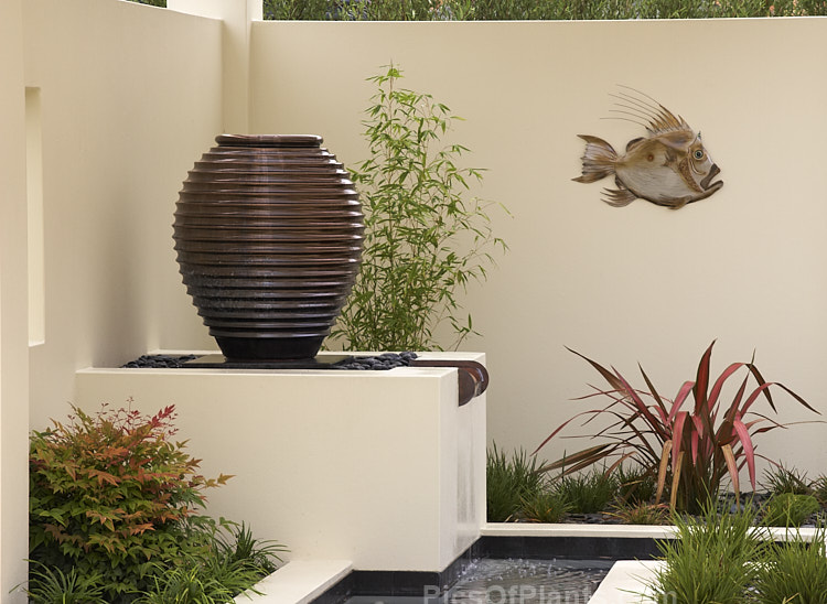 A bronze-coloured, urn-like water feature.