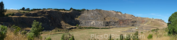 A panoramic view of Halswell Quarry, Christchurch, New Zealand. Once an important source of basalt that provided stone for local construction and ornament, the quarry is now part of a large recreational park.