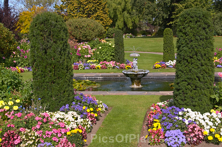 A formal garden that derives much of its colour from the abundant flowers of summer-blooming bedding plants.